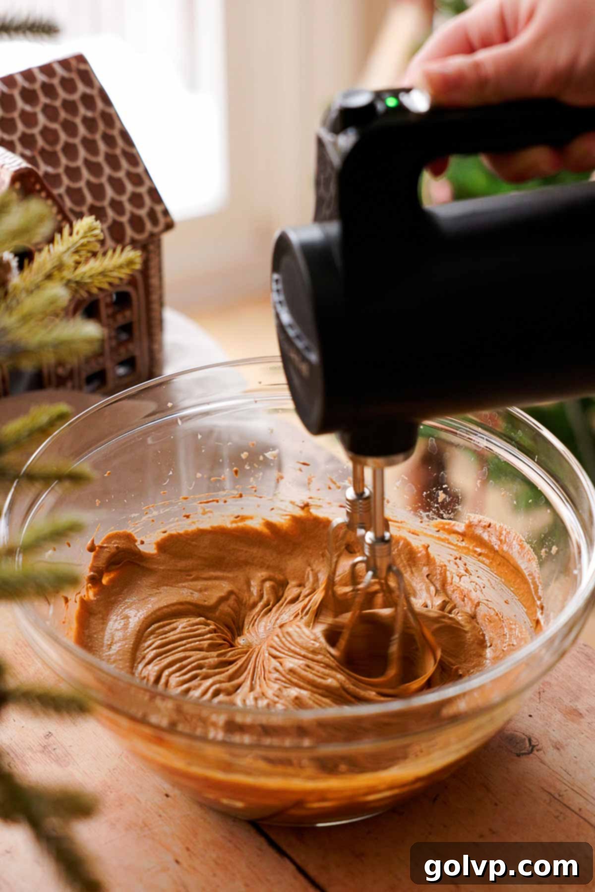 beating wet ingredients in large bowl for molded gingerbread cookies