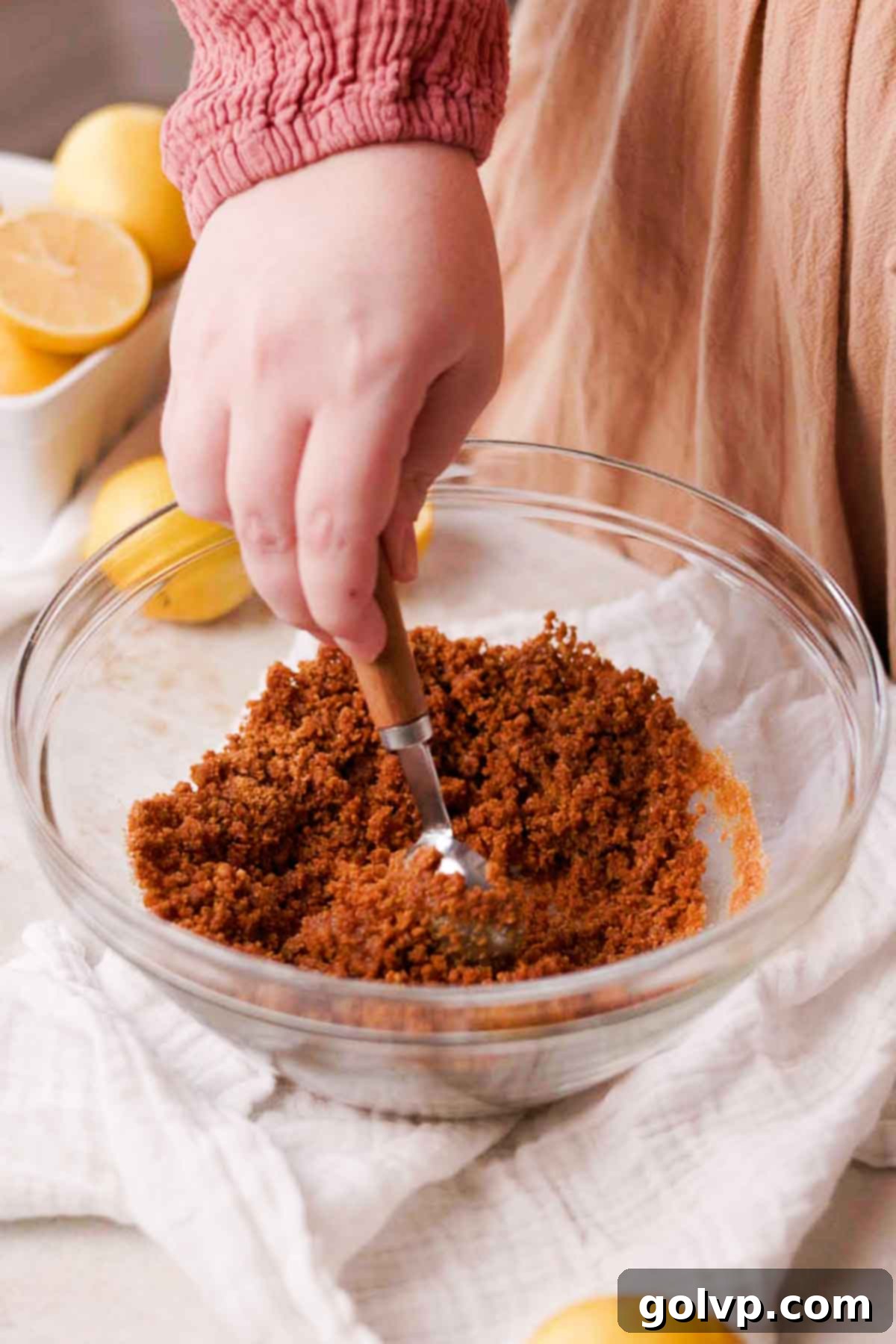 Sunshine Lemon Cheesecakes 5 stirring gingersnap crust mixture together in glass bowl
