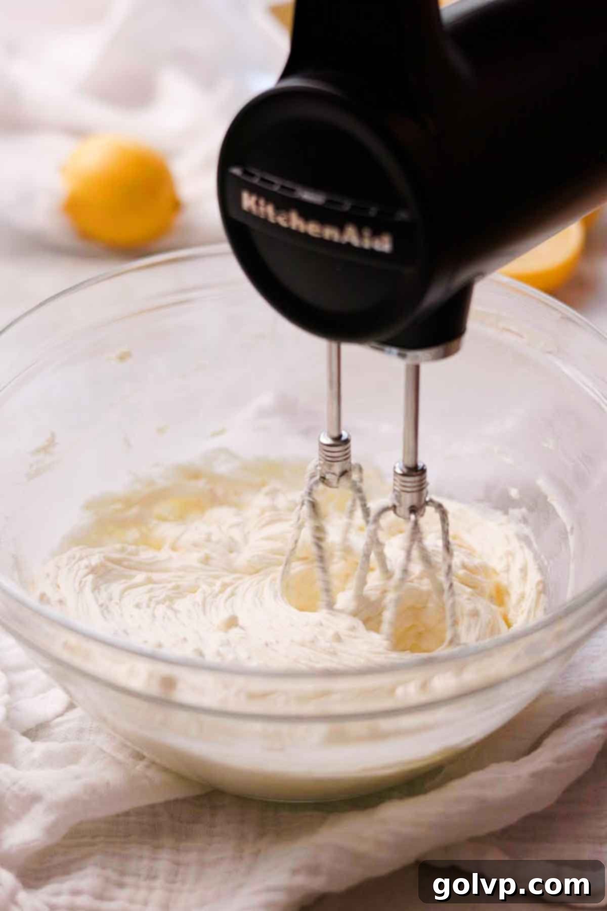 Sunshine Lemon Cheesecakes 8 beating cream cheese and lemon sugar together in large glass bowl