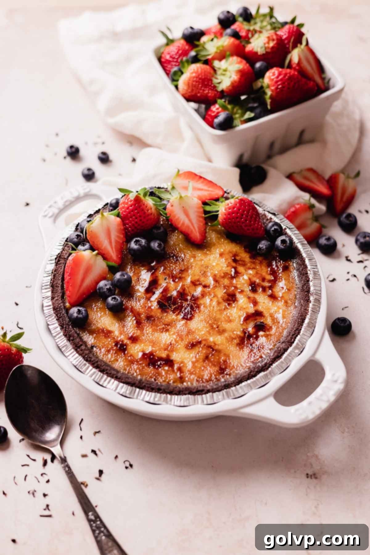 crene brulee pie with berries and cracked sugar topping