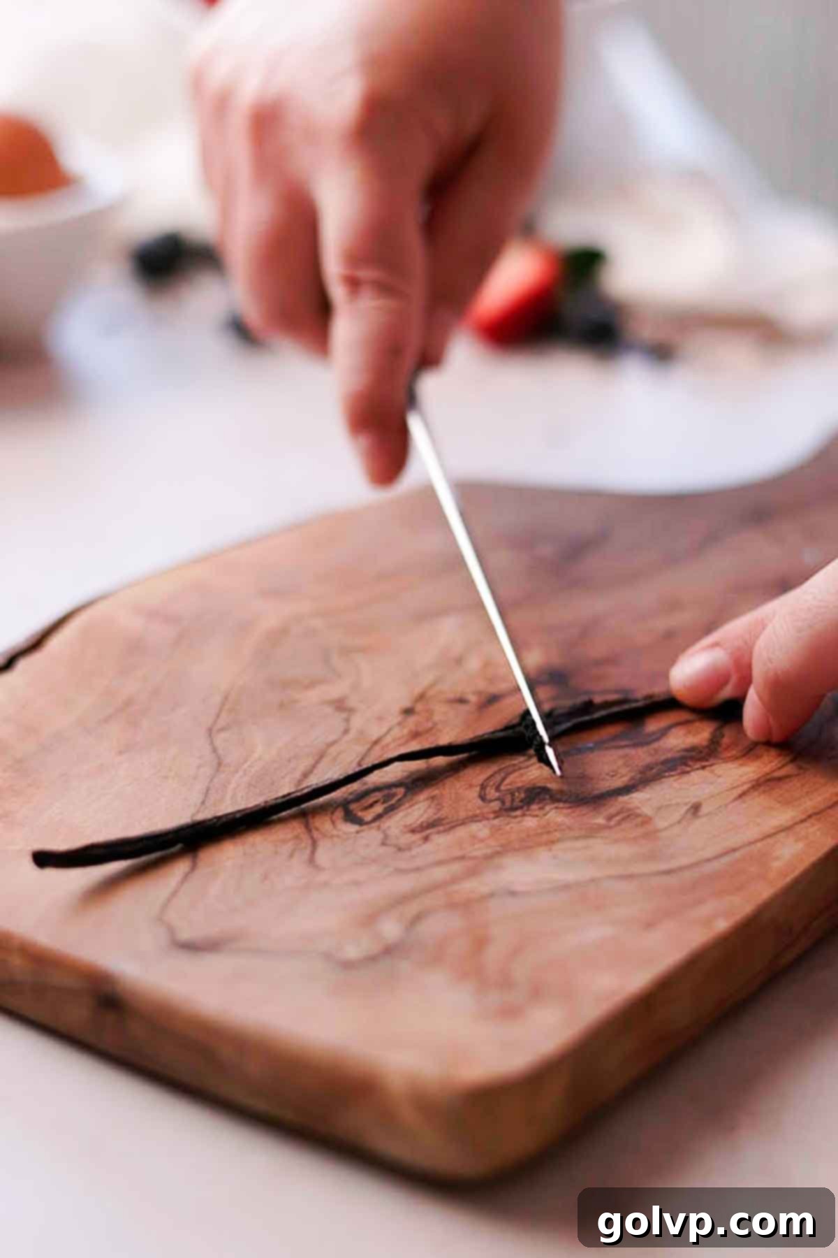 scraping out vanilla bean seeds from vanilla pod
