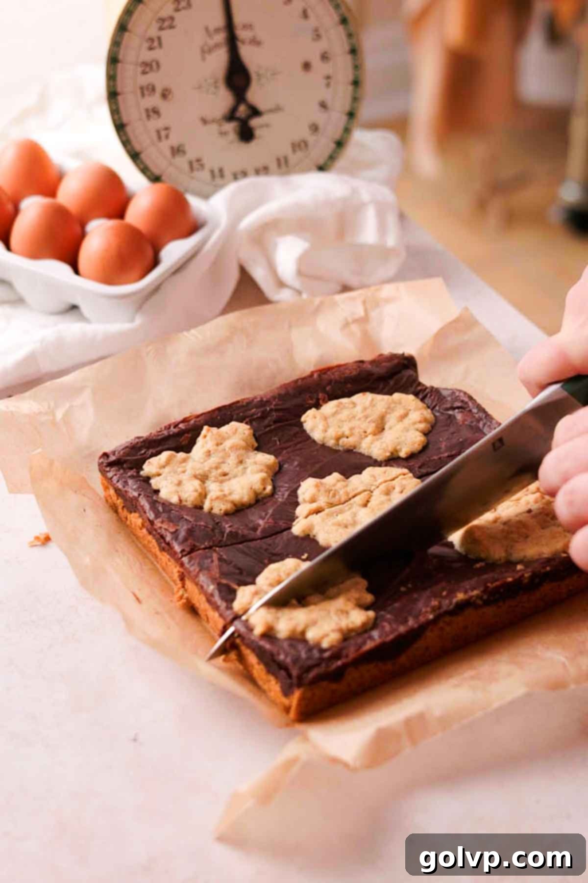 slicing baked oatmeal fudge bars in rectangles with knife