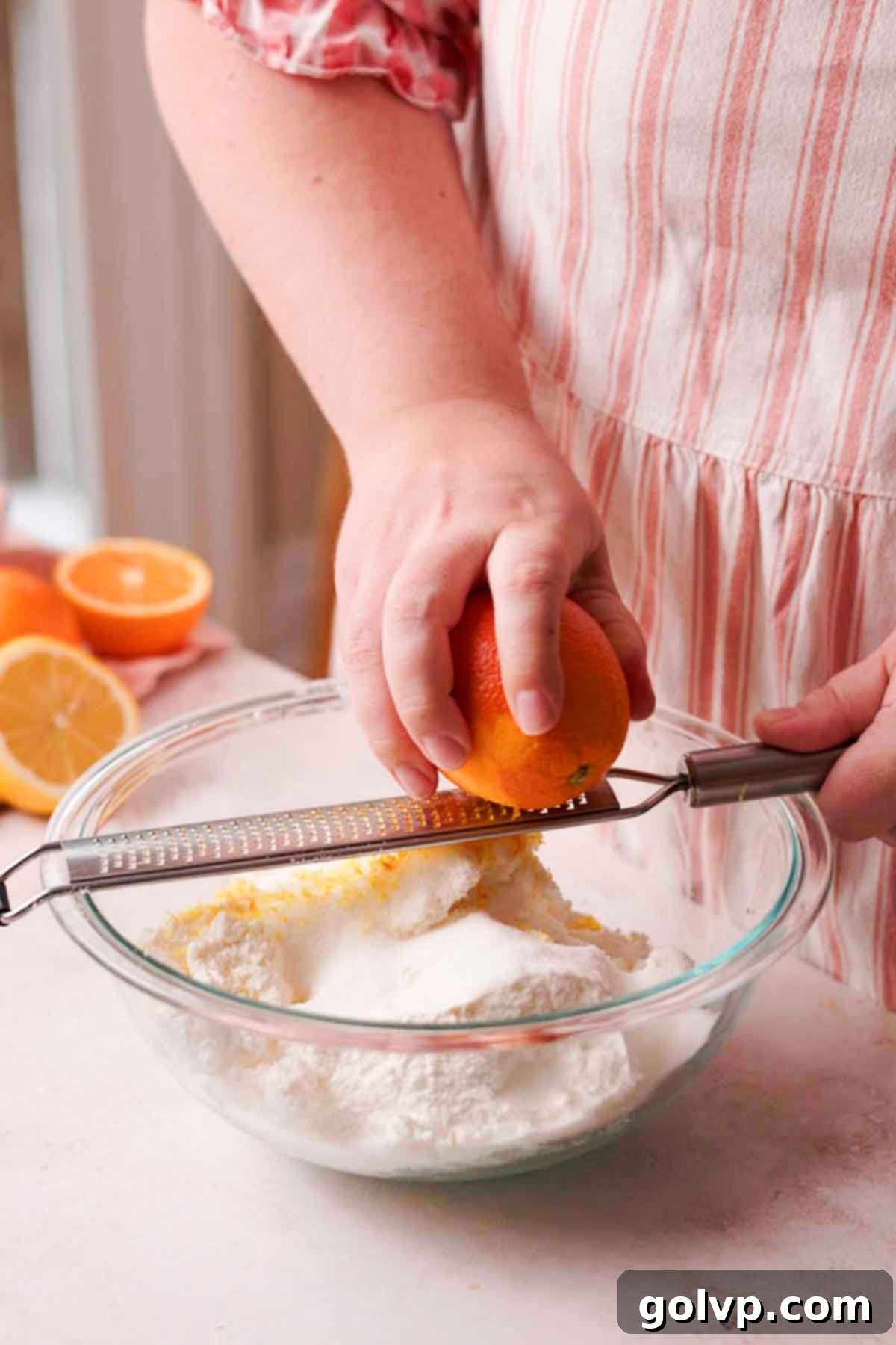 zesting orange zest into cottage cheese cheesecake batter