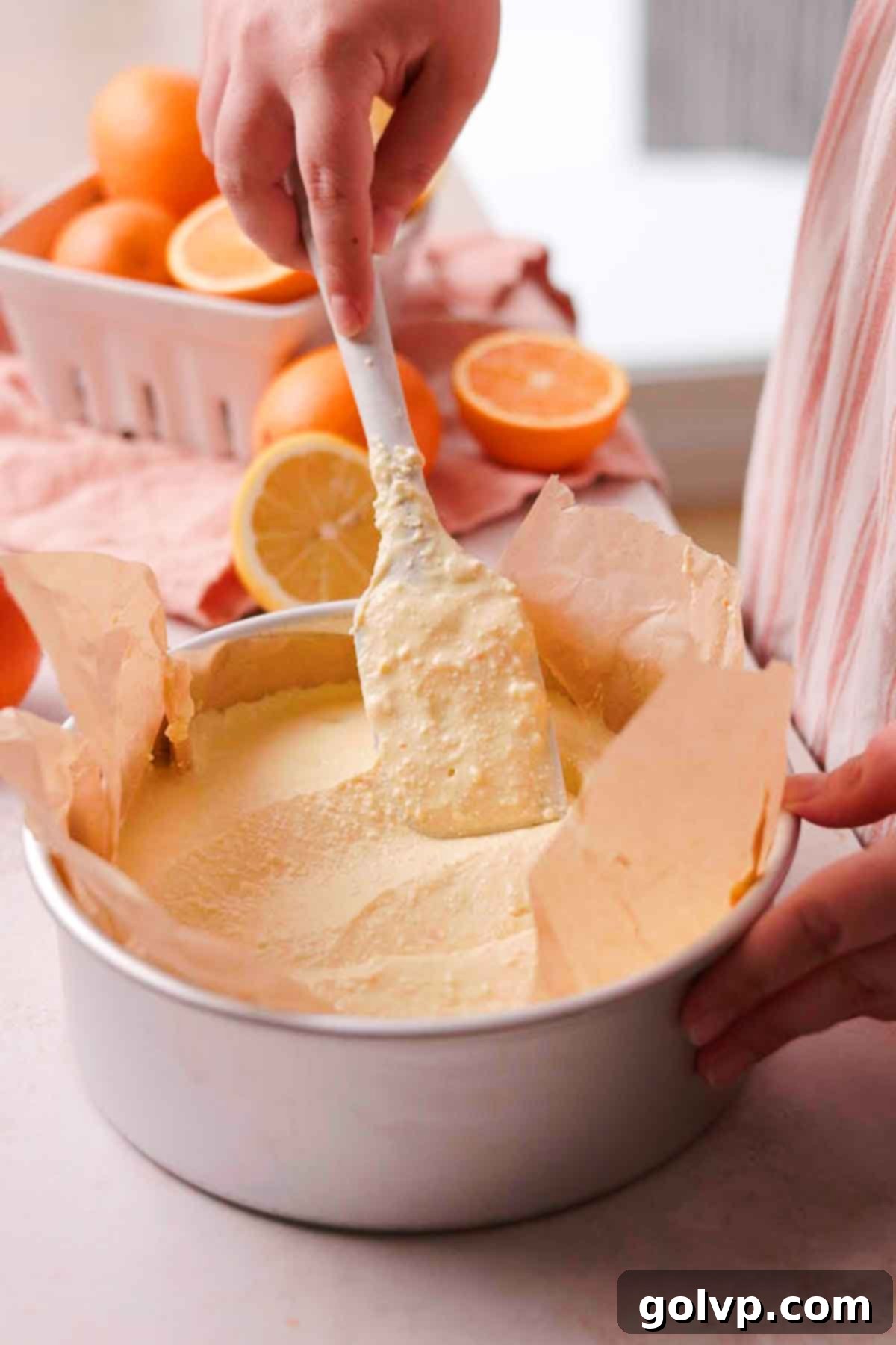 spreading cheesecake batter in cake pan