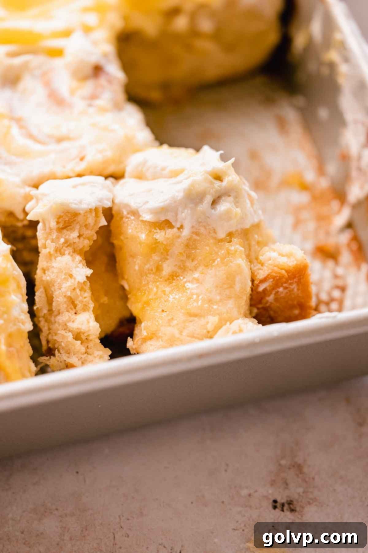 Close-up of a lemon curd roll, showing the soft, fluffy interior and gooey lemon curd filling.