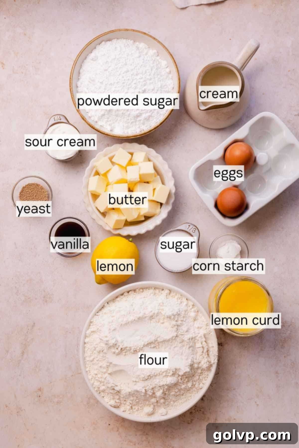 Assortment of fresh ingredients for lemon rolls, including lemons, butter, flour, and eggs.