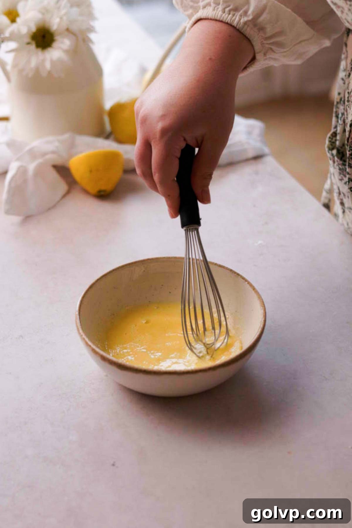 whisking egg wash in a small bowl