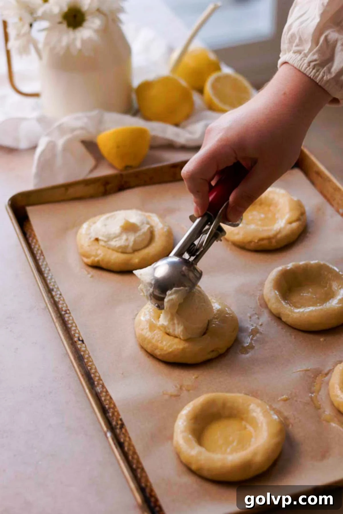 scooping cottage cheese filling into brioche buns