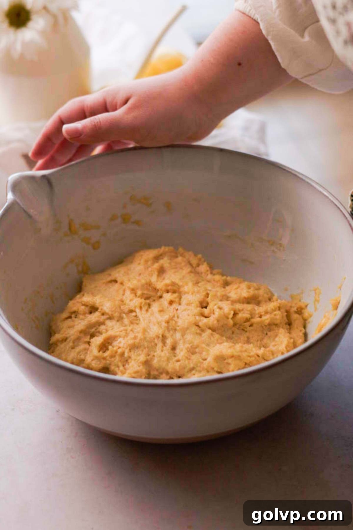 risen brioche dough in large bowl
