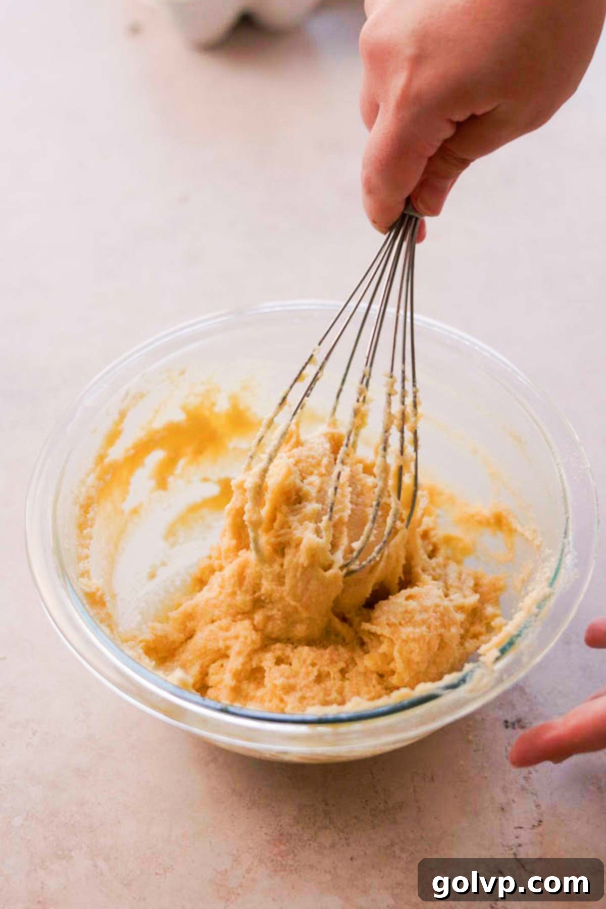 Double Almond Gooey Coffee Cake 13 whisking almond frangipane in a glass bowl by hand