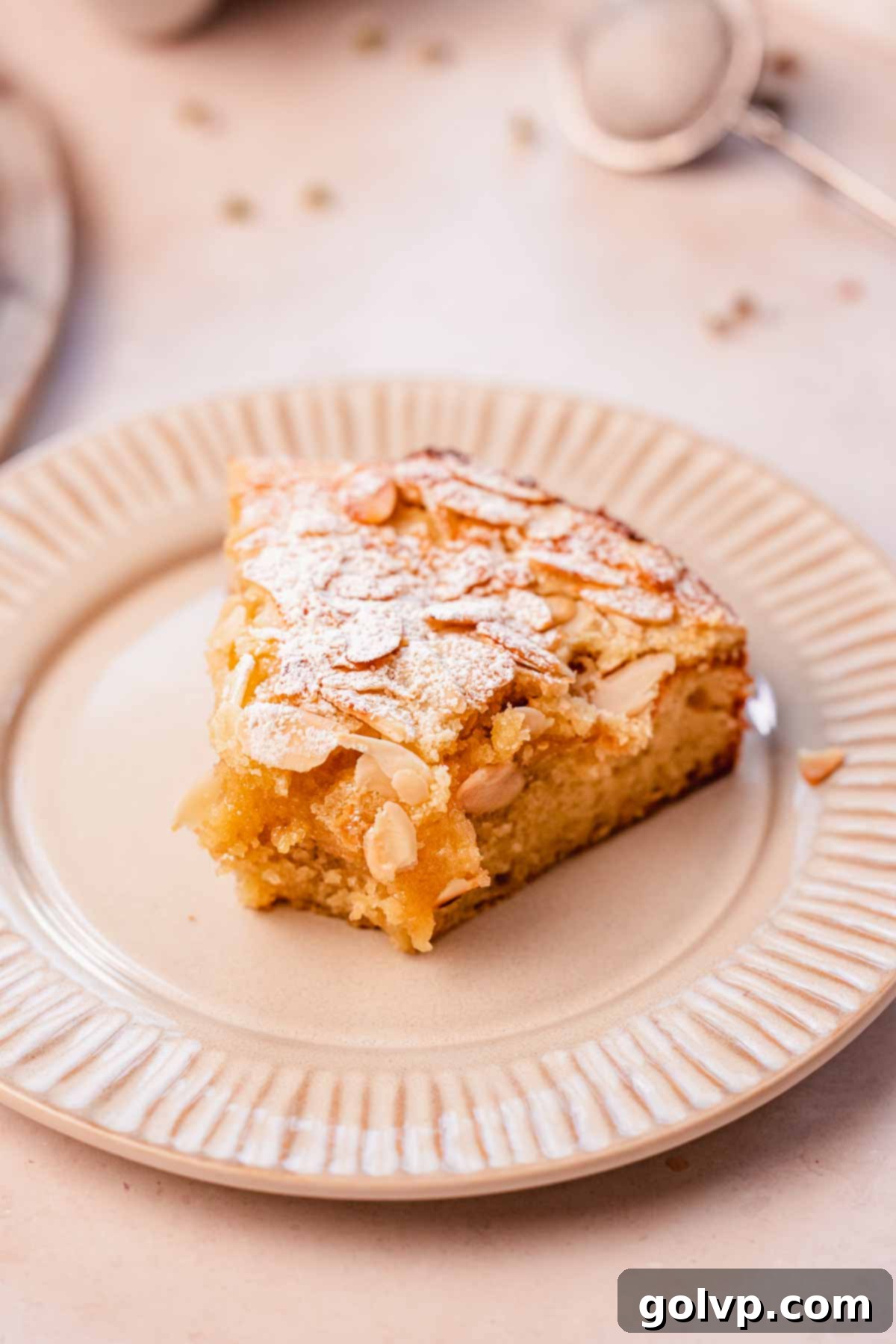 Double Almond Gooey Coffee Cake 19 slice of almond coffee cake with a bite taken out of it