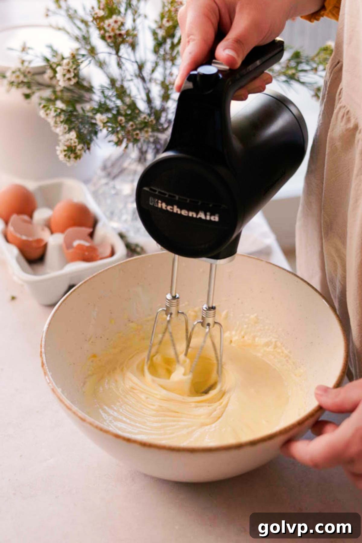 Double Almond Gooey Coffee Cake 6 beating almond coffee cake with an electric mixer in a bowl