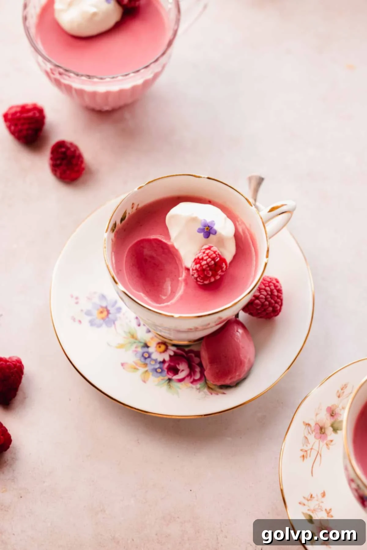 raspberry posset in teacup with small spoon