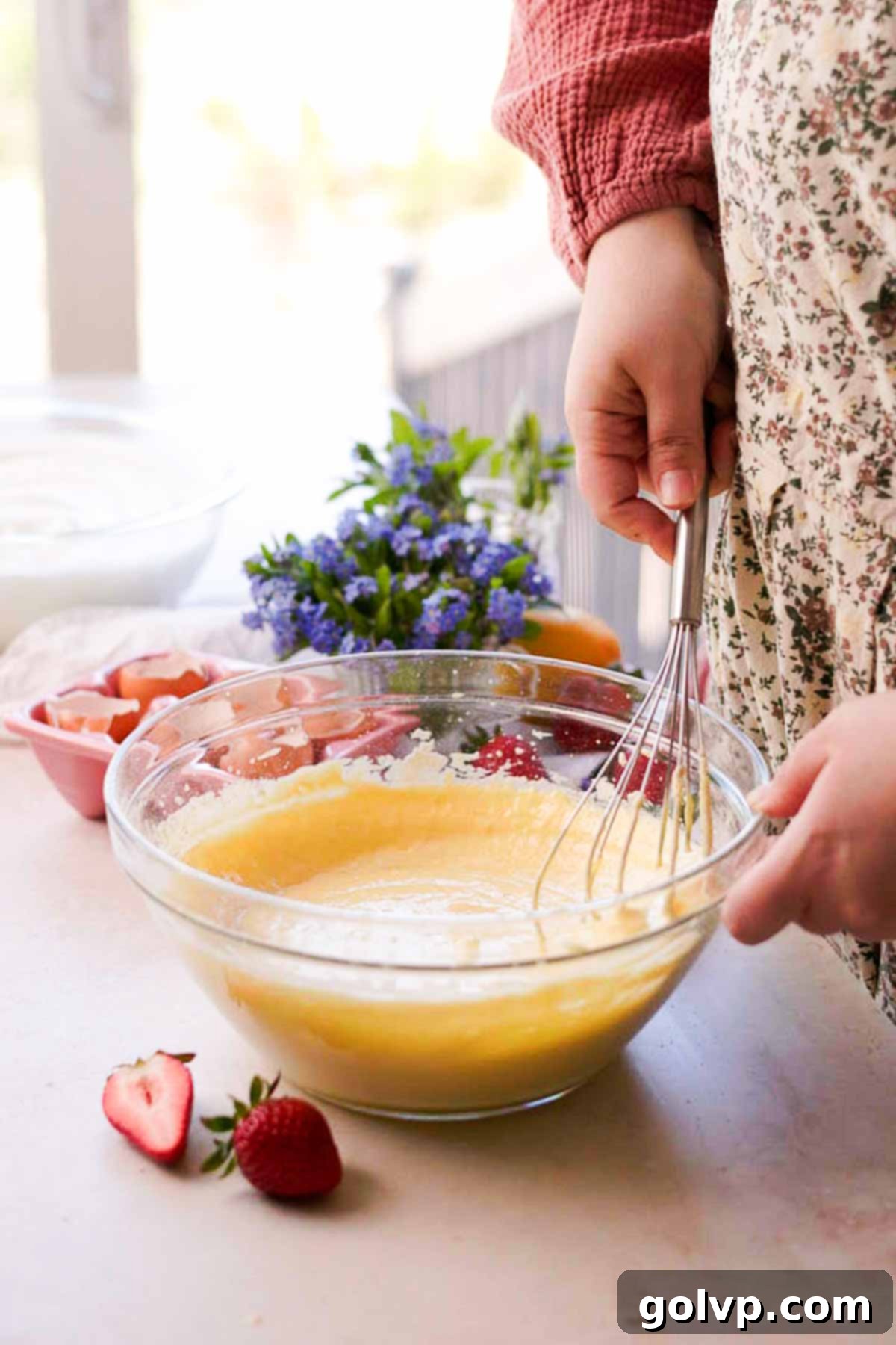 folding flour into chiffon cake batter with a wire whisk by hand