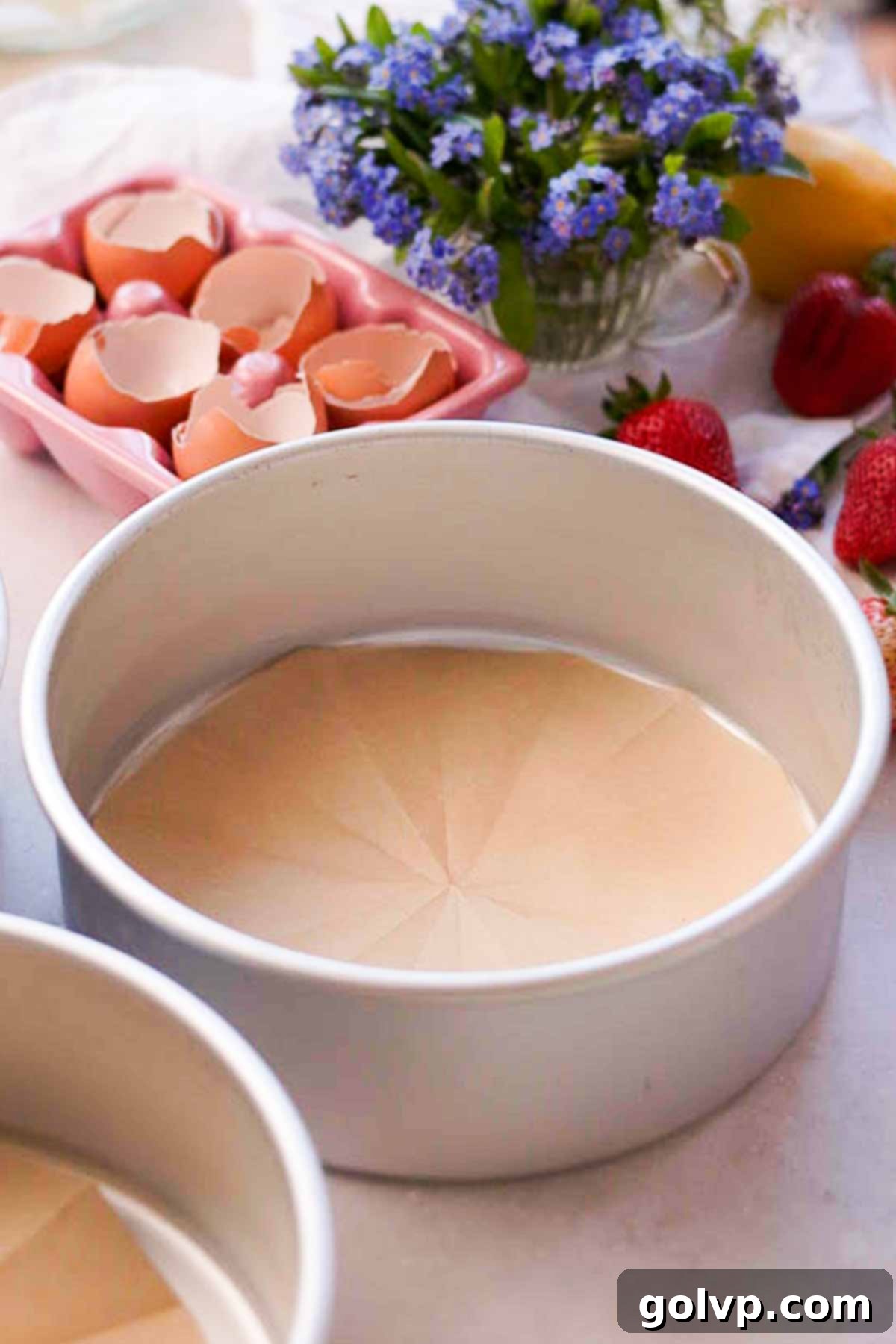 bottoms of cake pans lined with rounds of parchment paper