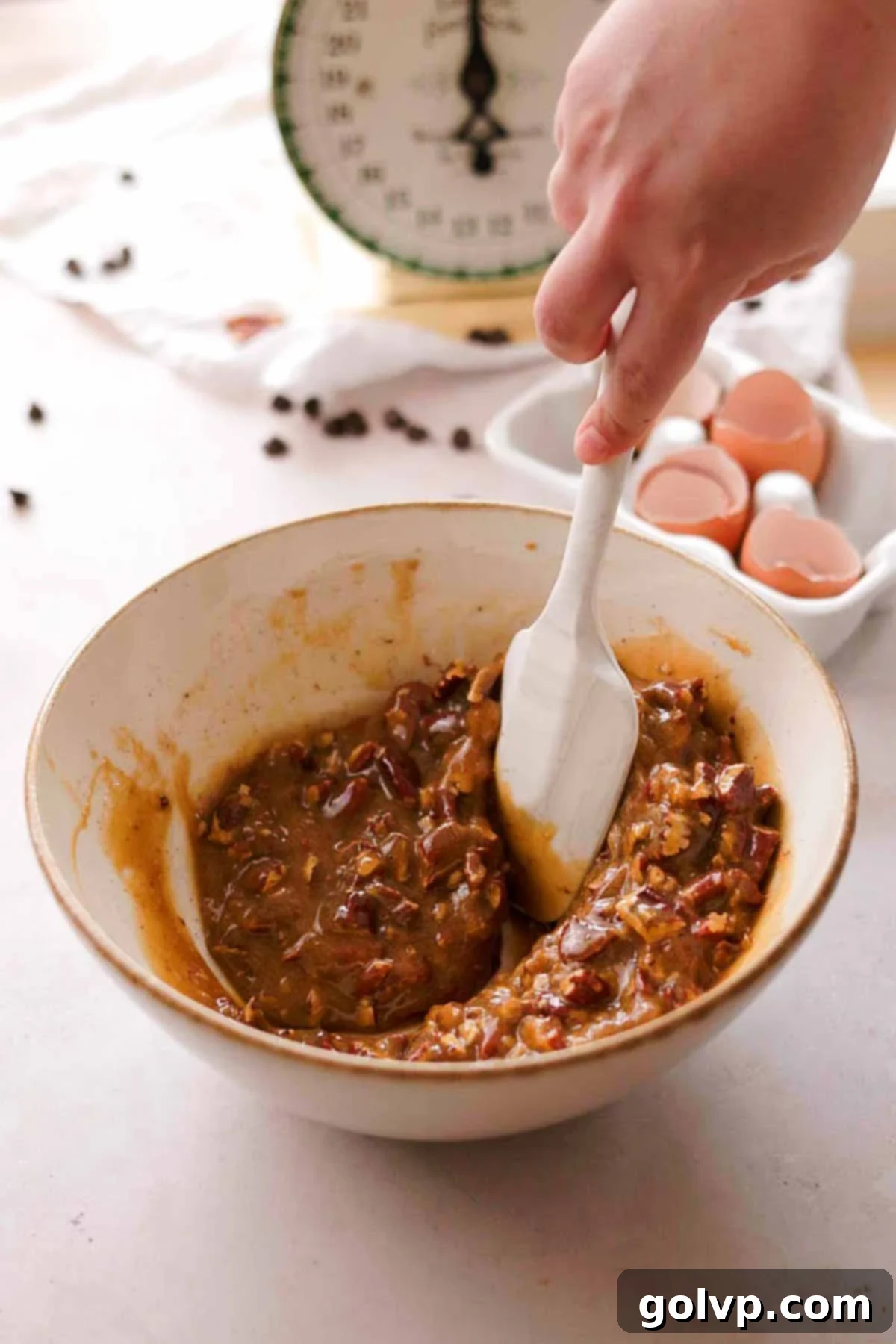 mixing pecans into pecan pie butter