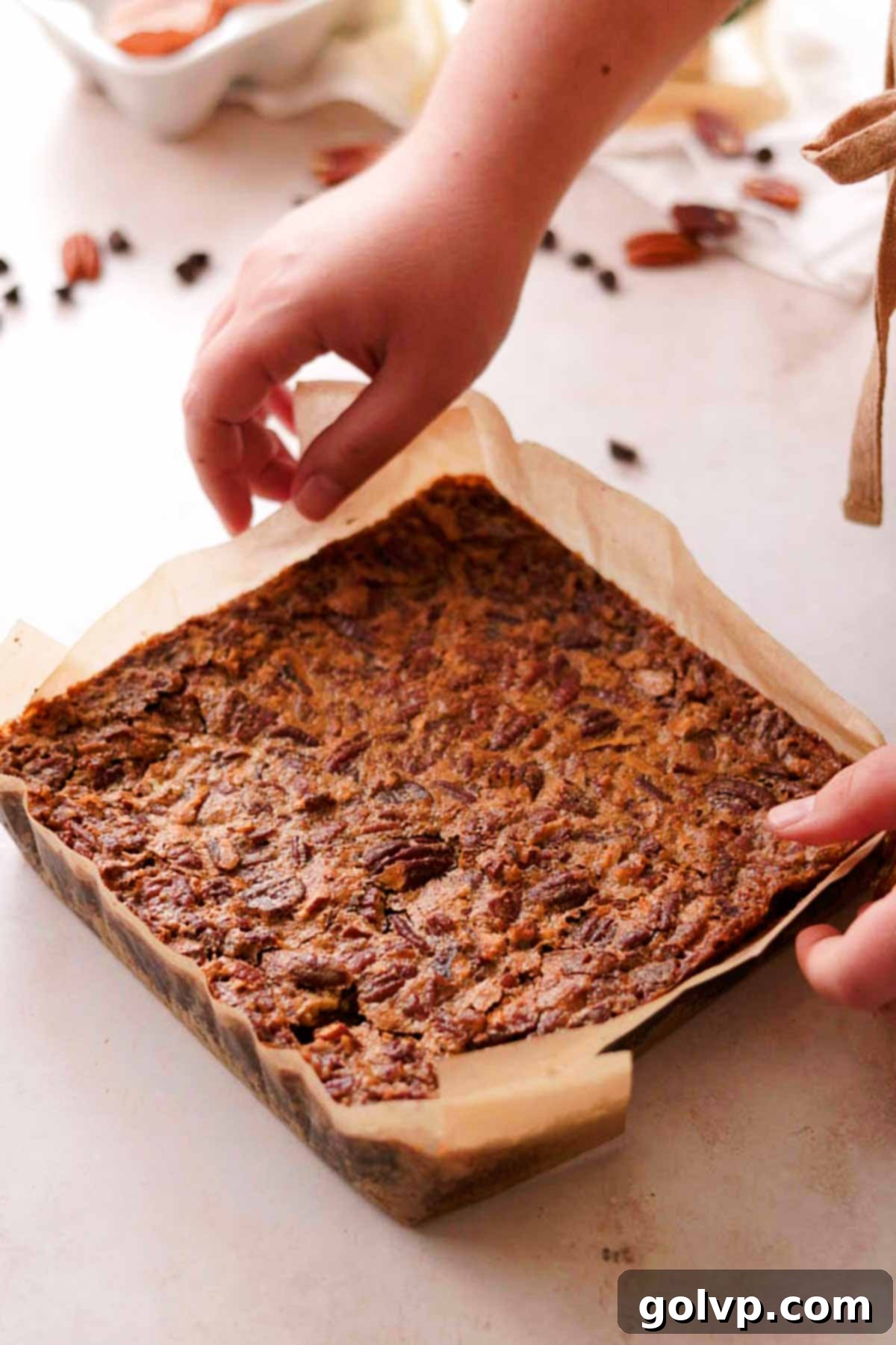 baked pecan pie brownies fresh out of the oven, showing the golden-brown, crackly top