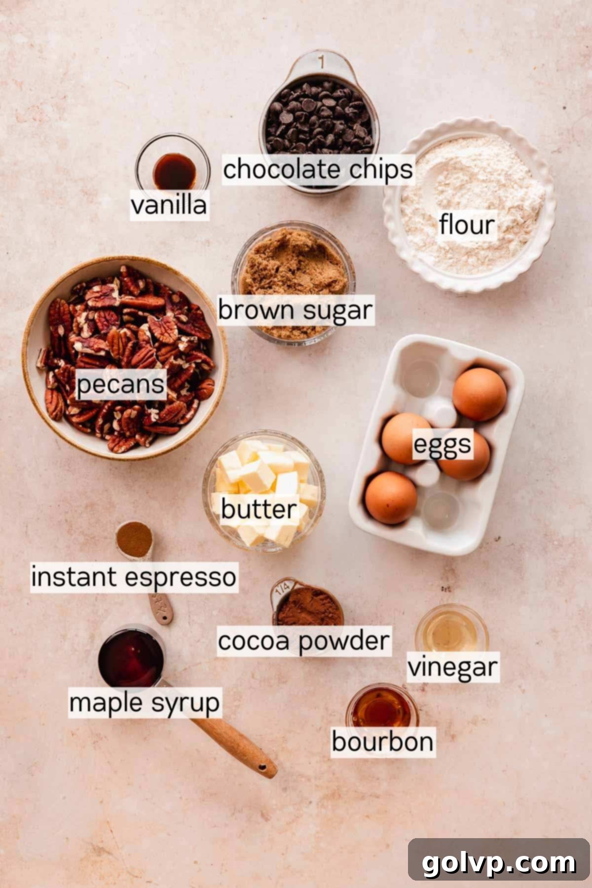 ingredients for pecan pie brownies laid out in bowls on a white surface
