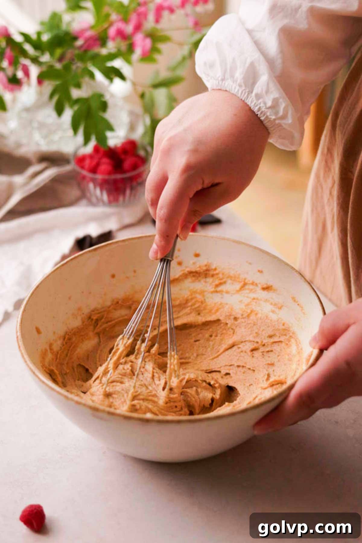 Mixing the cookie dough wet ingredients with a whisk in a bowl