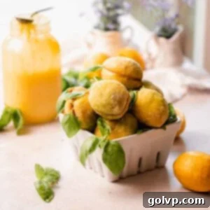 A bowl of delightful Italian lemon cookies, each sugar-coated and adorned with a fresh basil leaf, perfectly showcasing their vibrant appearance.