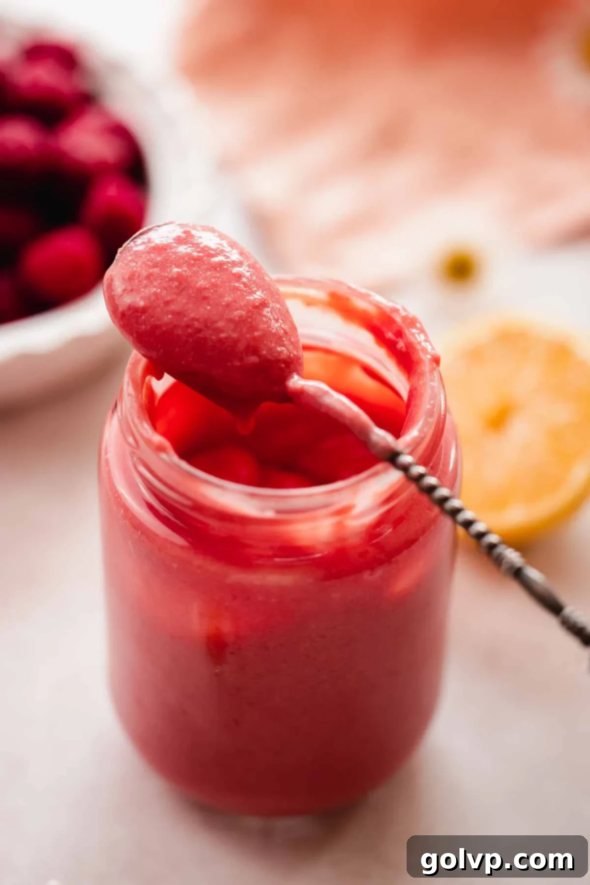 closeup of creamy cherry curd texture in spoon