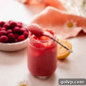 cherry curd dripping off of silver spoon in jar
