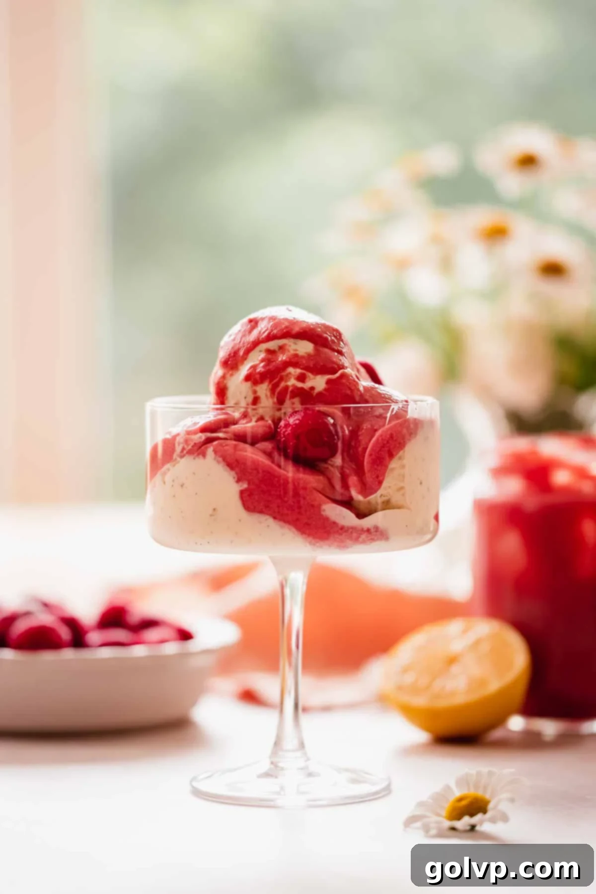 cherry curd over ice cream in coupe cup