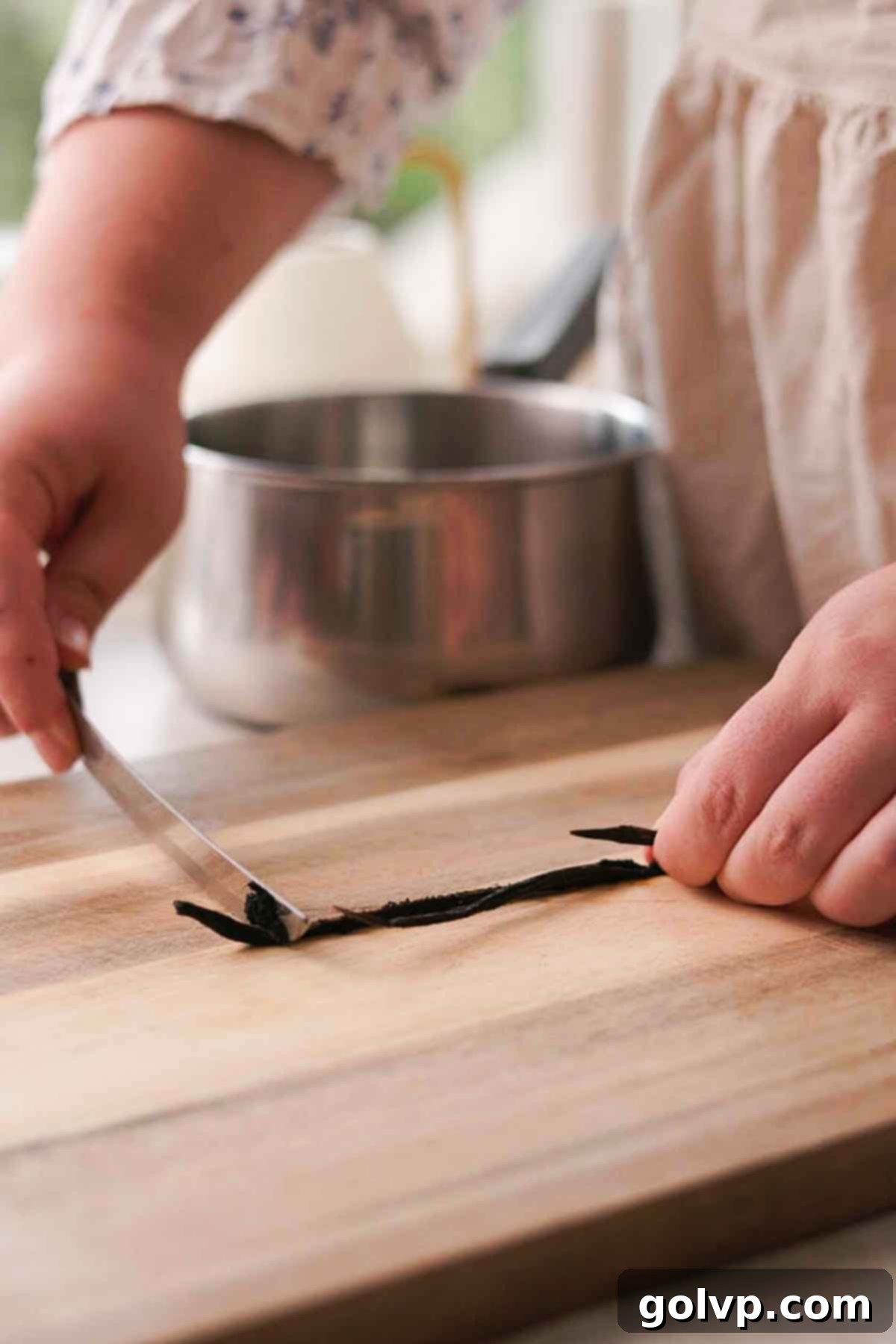 Vanilla bean being split and scraped for seeds