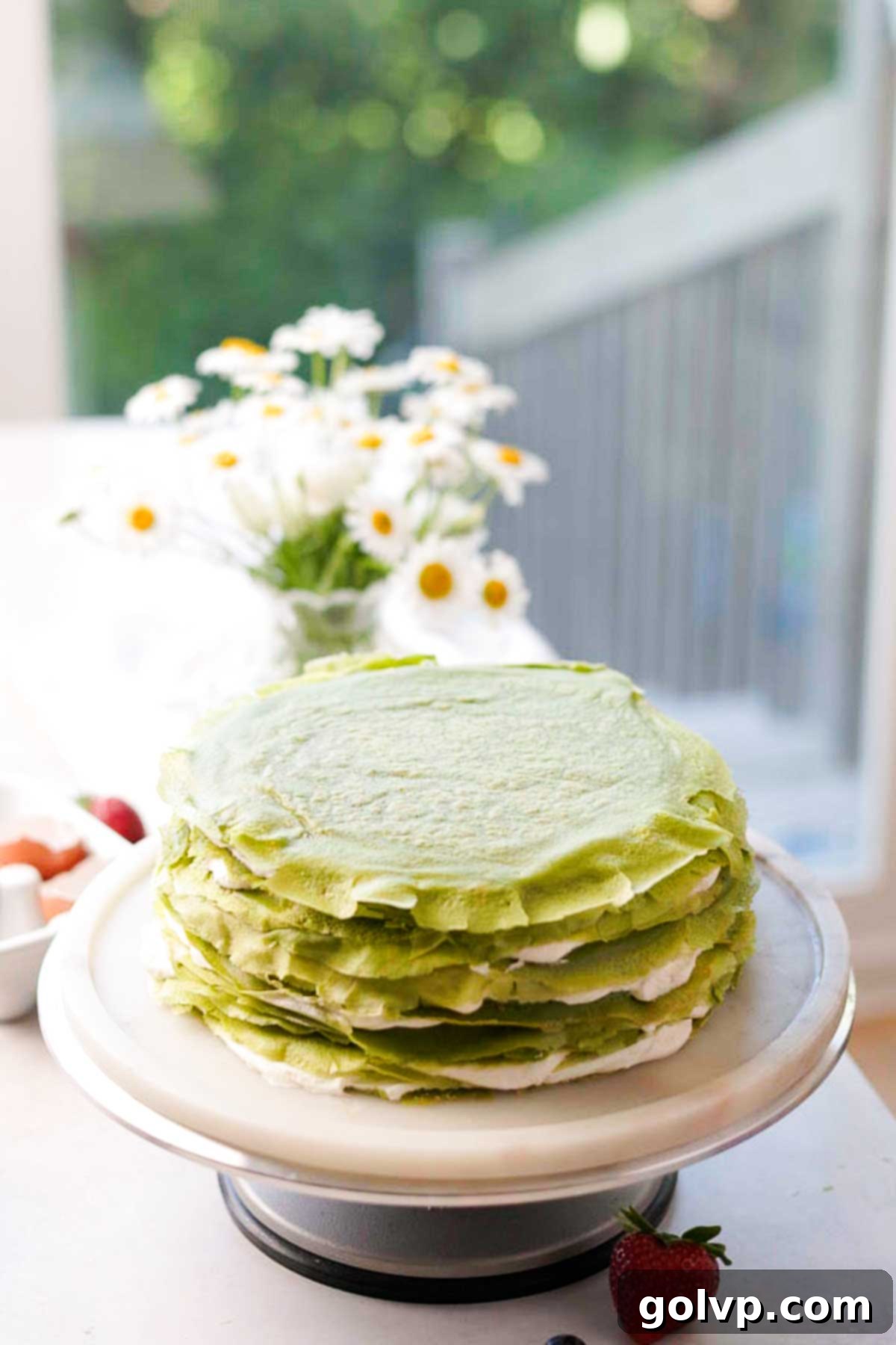 stacked matcha crepe cake with layers of cream in between