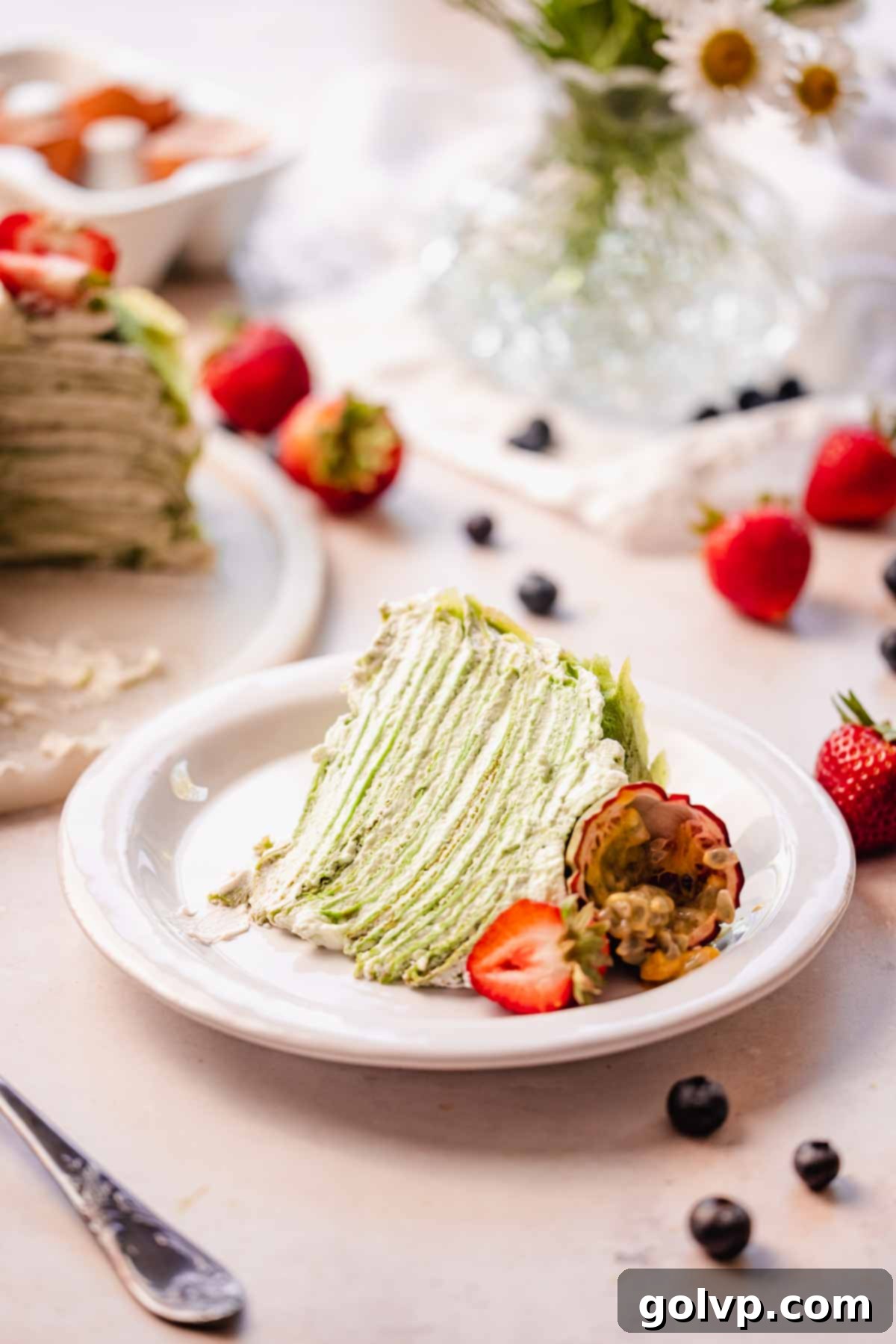 a slice of matcha crepe cake on a plate