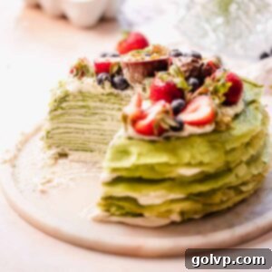 a matcha crepe cake cutaway with visible thin crepe and filling layers inside