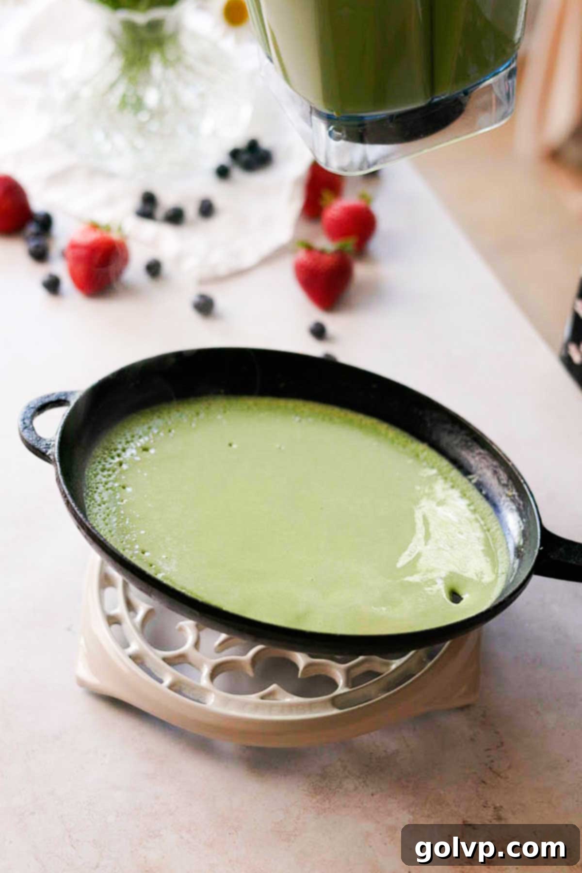tilting the pan with crepe batter to let it evenly cover the surface