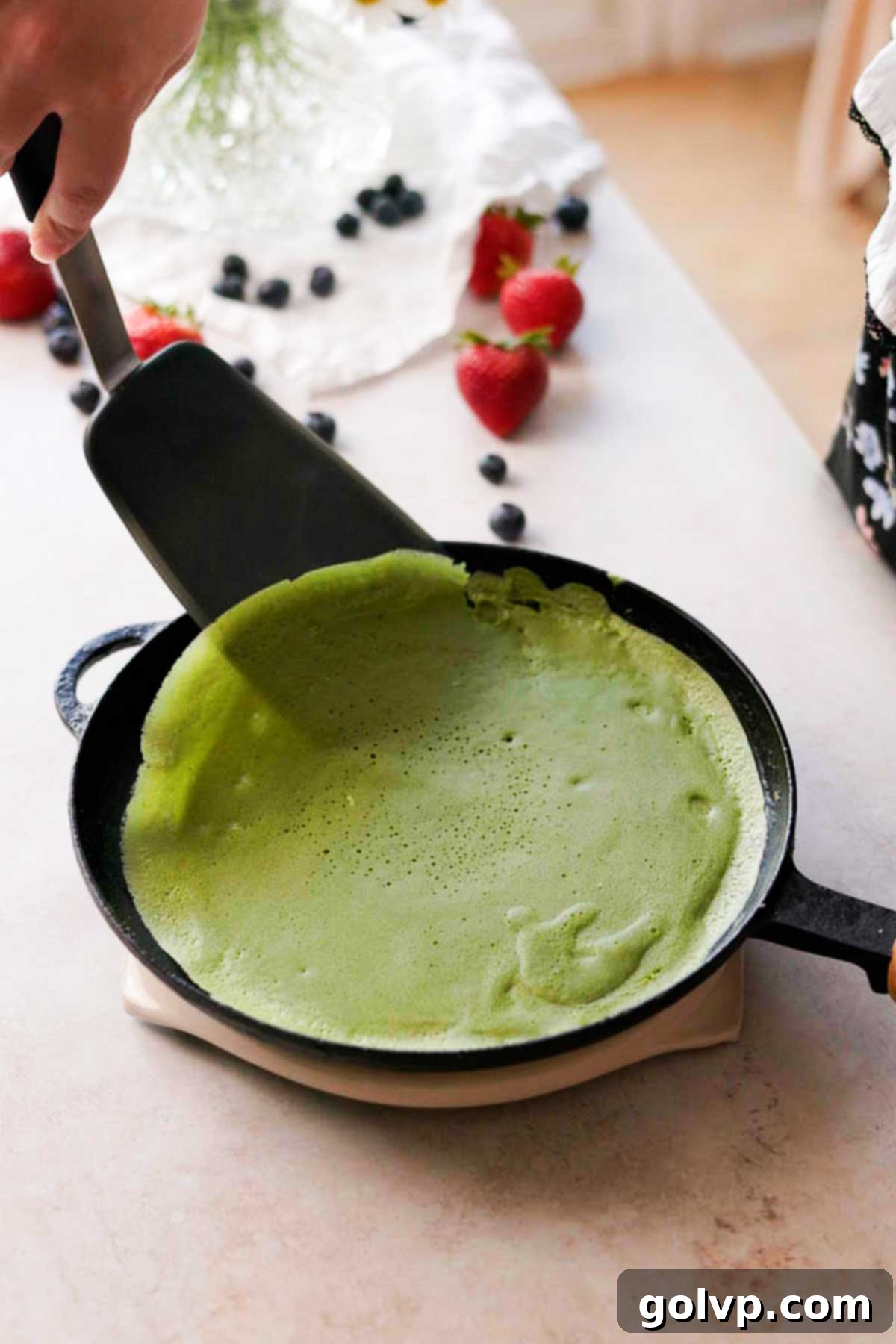 loosening the cooked crepe to flip it