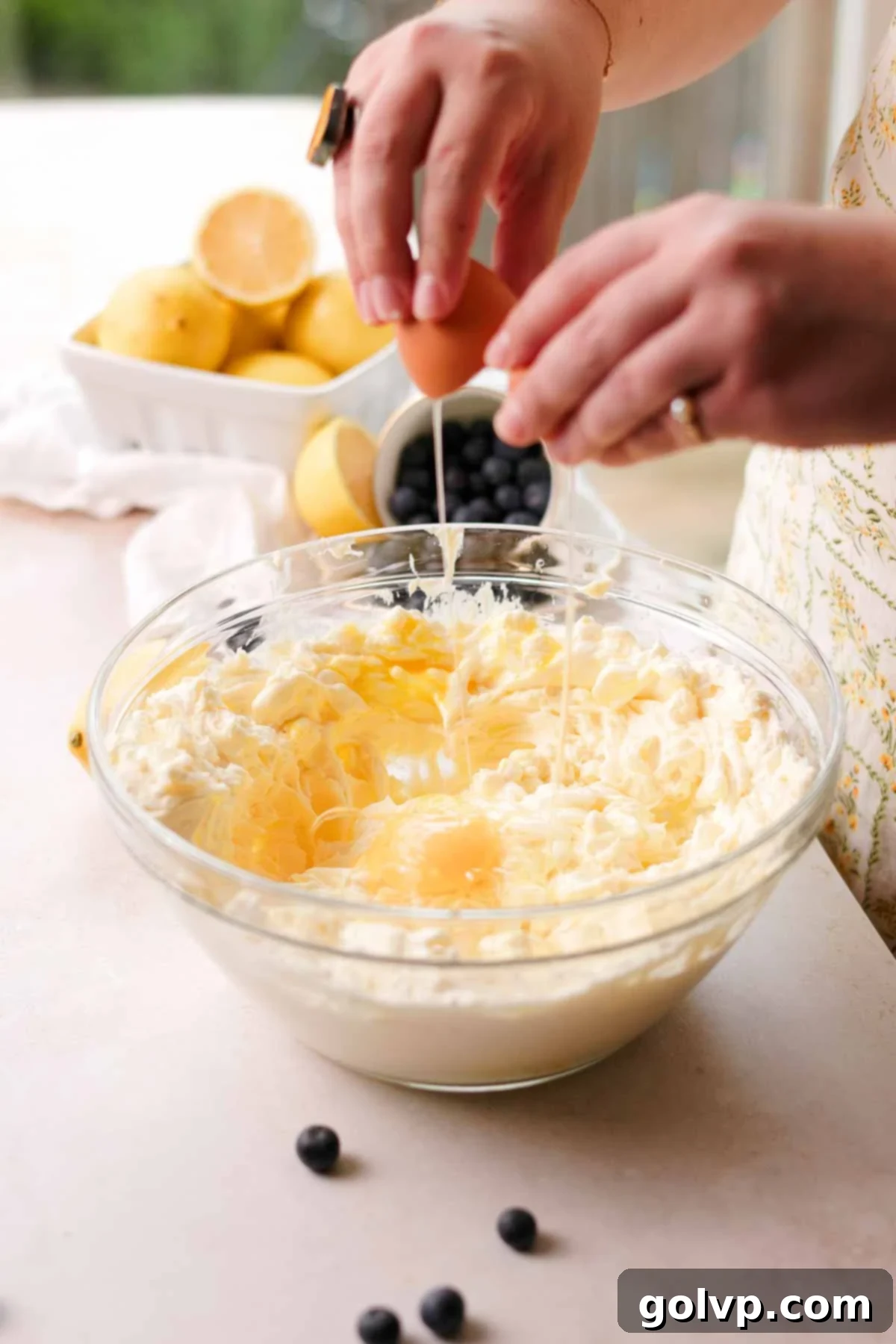 adding eggs into the cheesecake mix