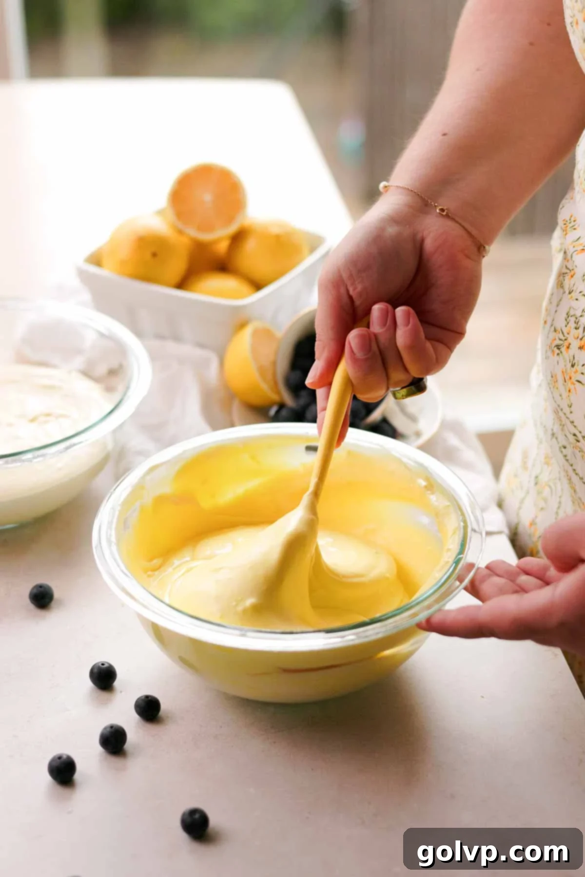 mixing lemon cheesecake batter with a spatula
