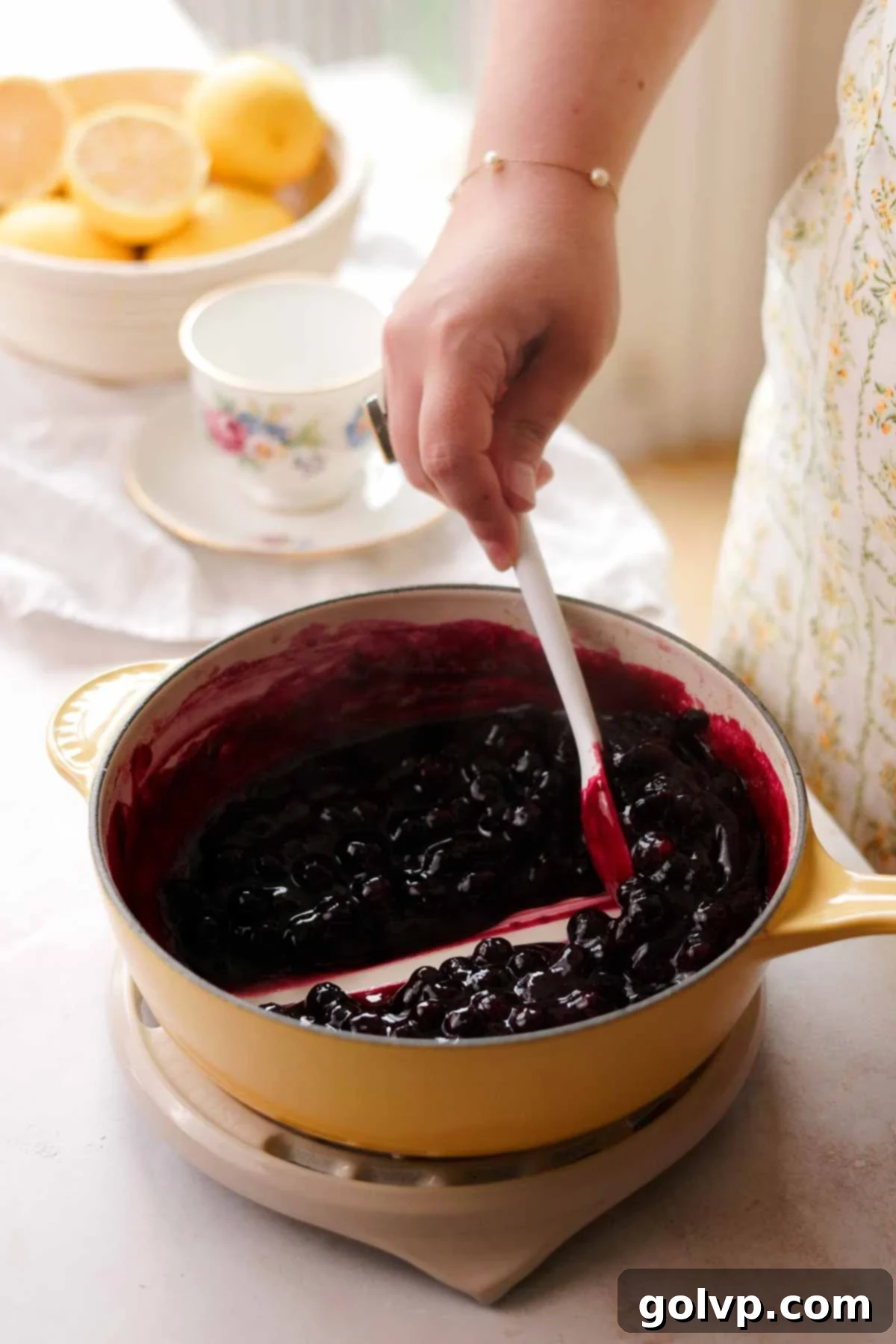 cooking blueberry sauce in a pot