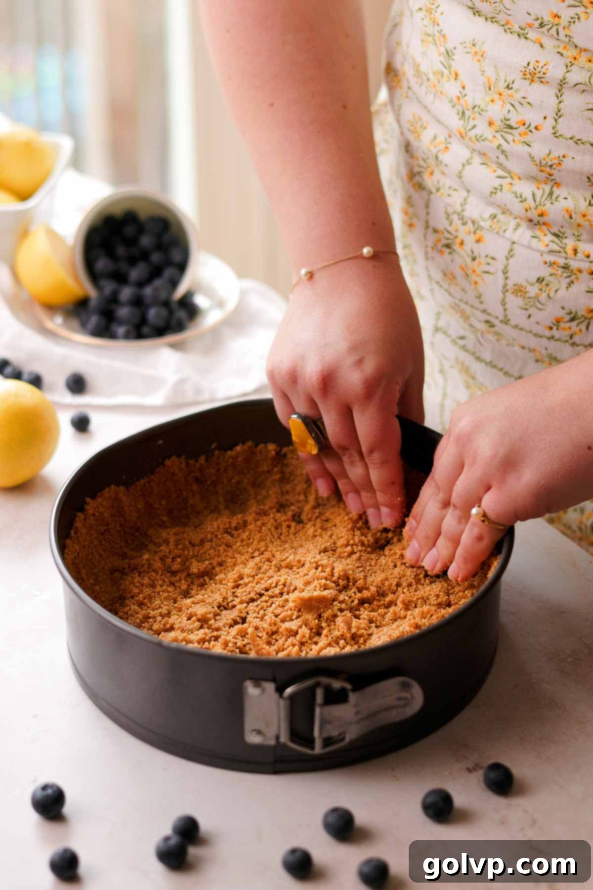 packing crust in the pan with hands