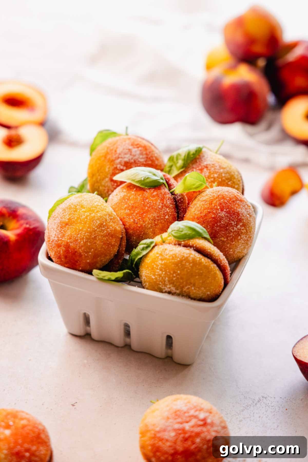 peach cookies with basil leafs sitting in a basket