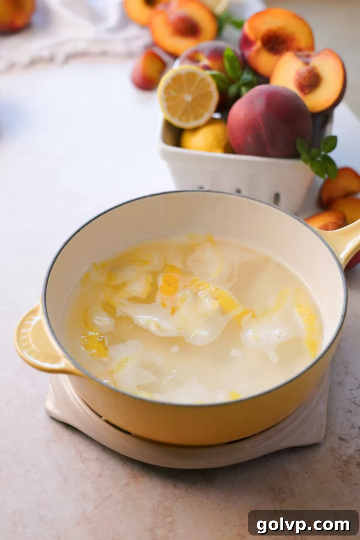 hot lemon peach syrup with lemon zest in a pot