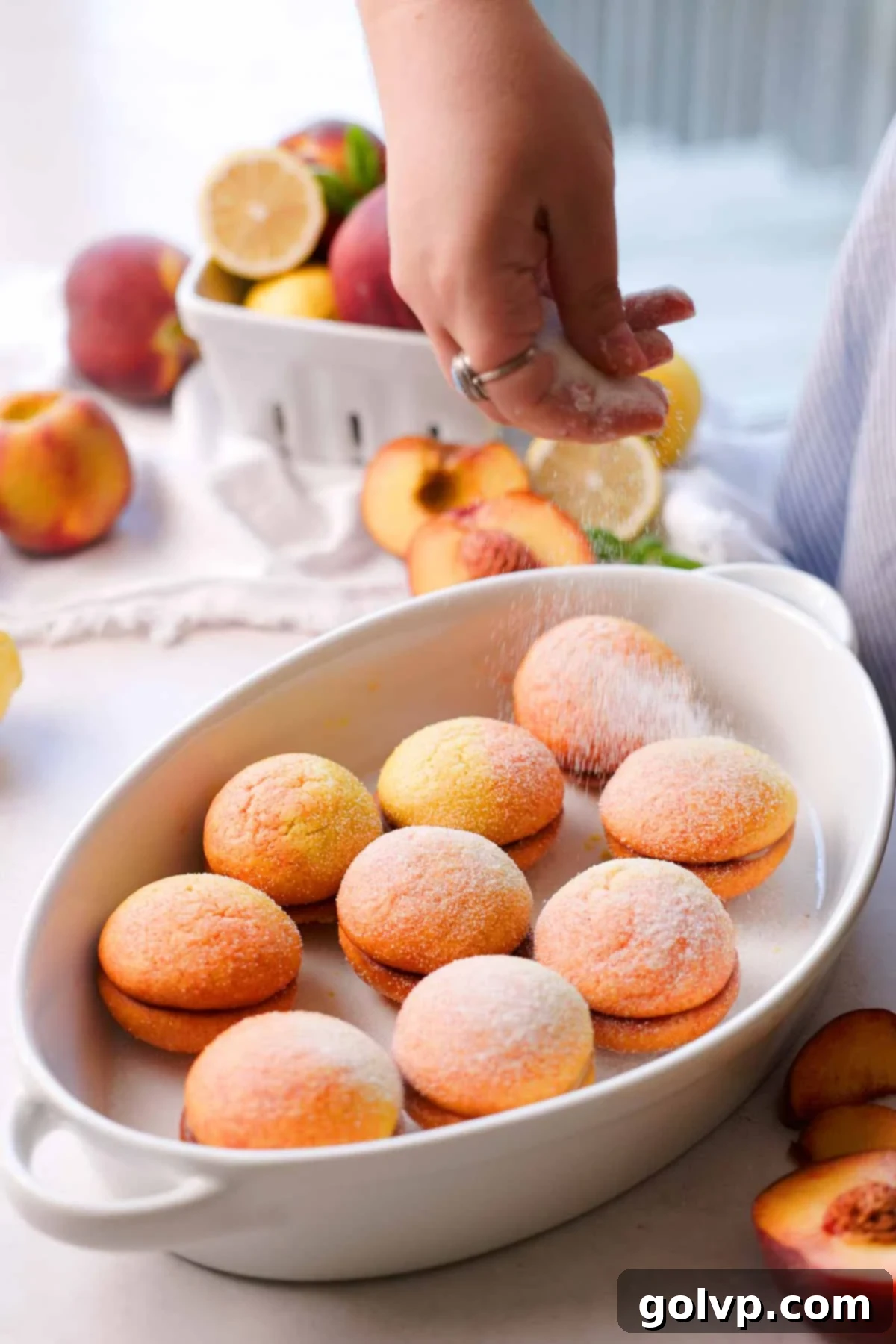 sprinkling peach cookies with sugar on top