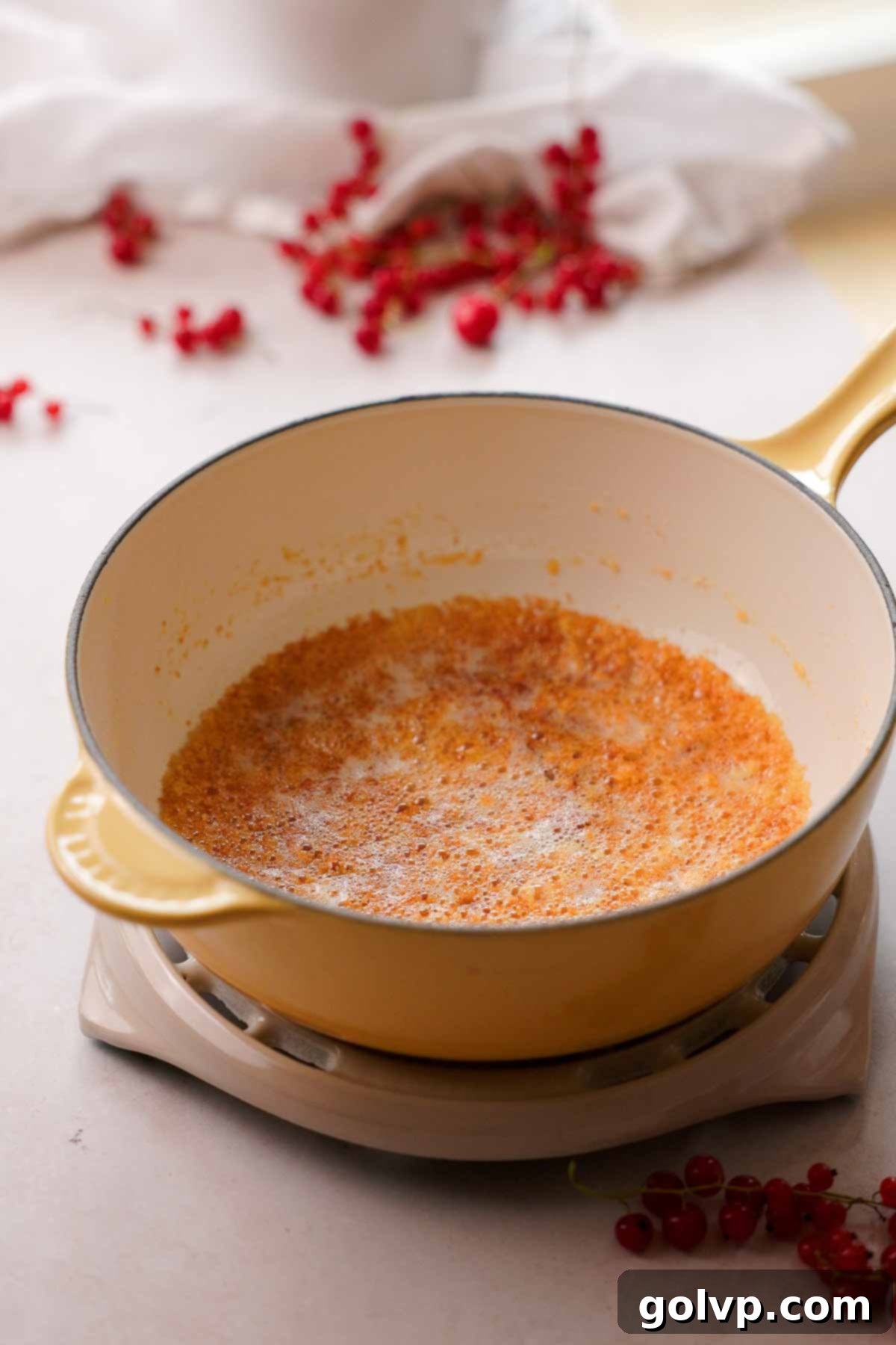 Close-up of brown butter sizzling gently in a hot pot, showing golden-brown milk solids.