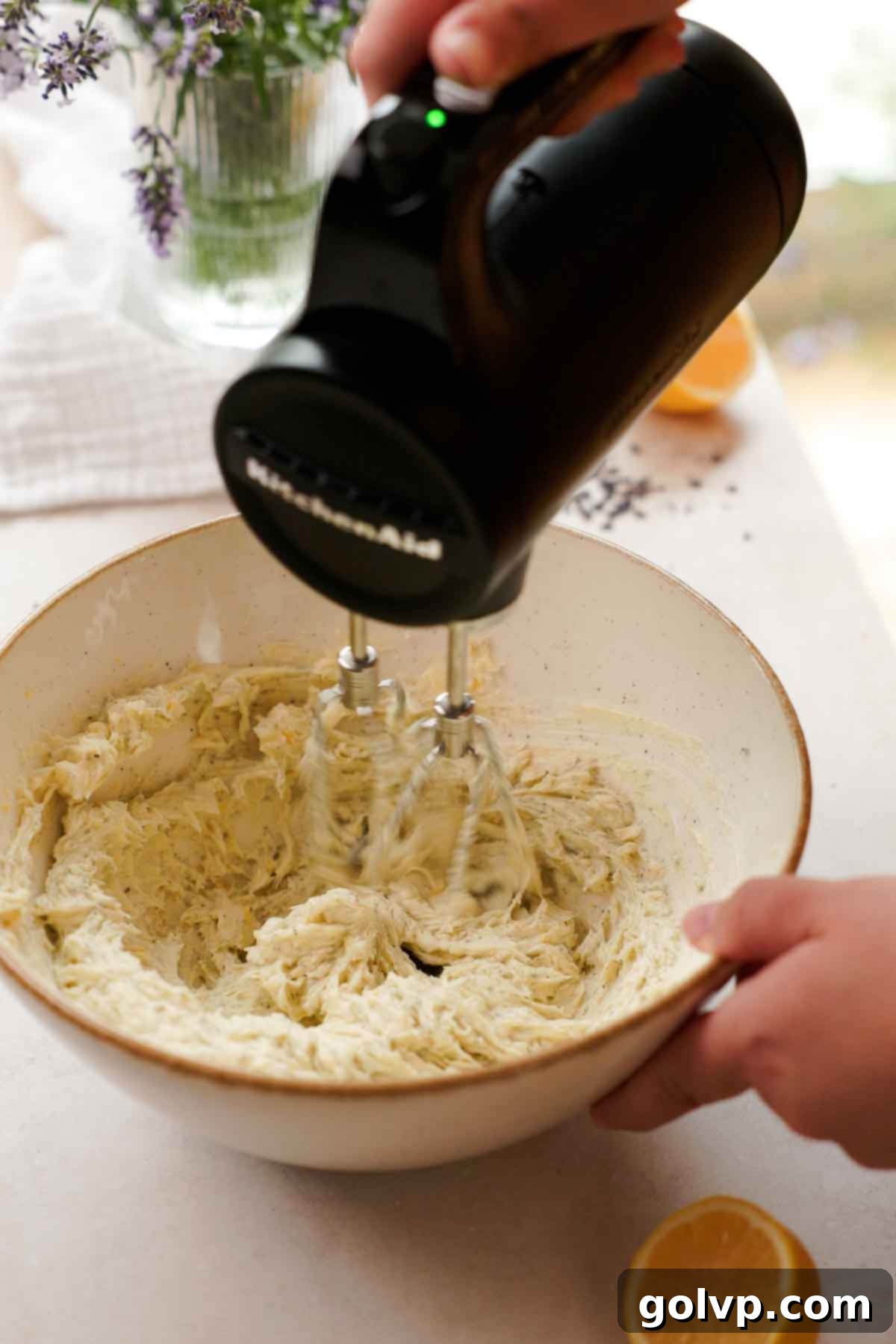 beating butter and sugar in a large bowl with electric mixer