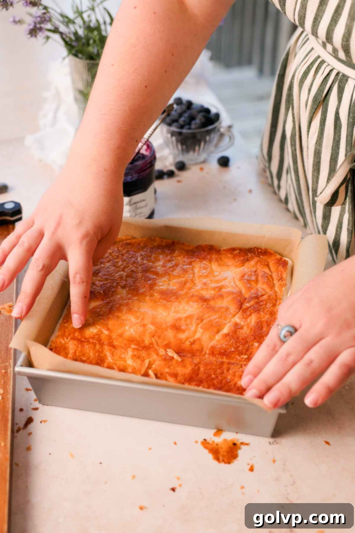 placing the second layer of caramelized puff pastry onto the no-churn ice cream mixture