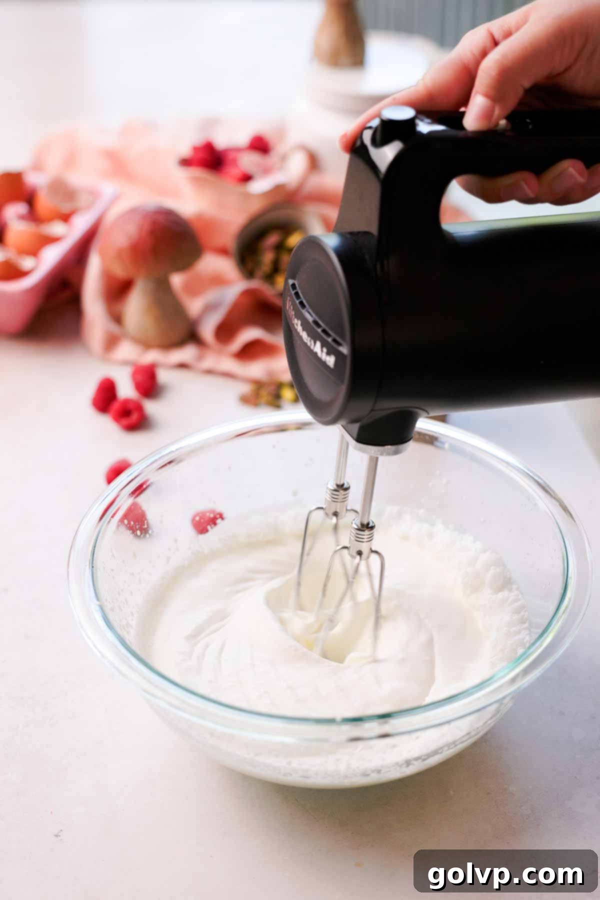 whipping cream to medium peak with electric mixer in glass bowl