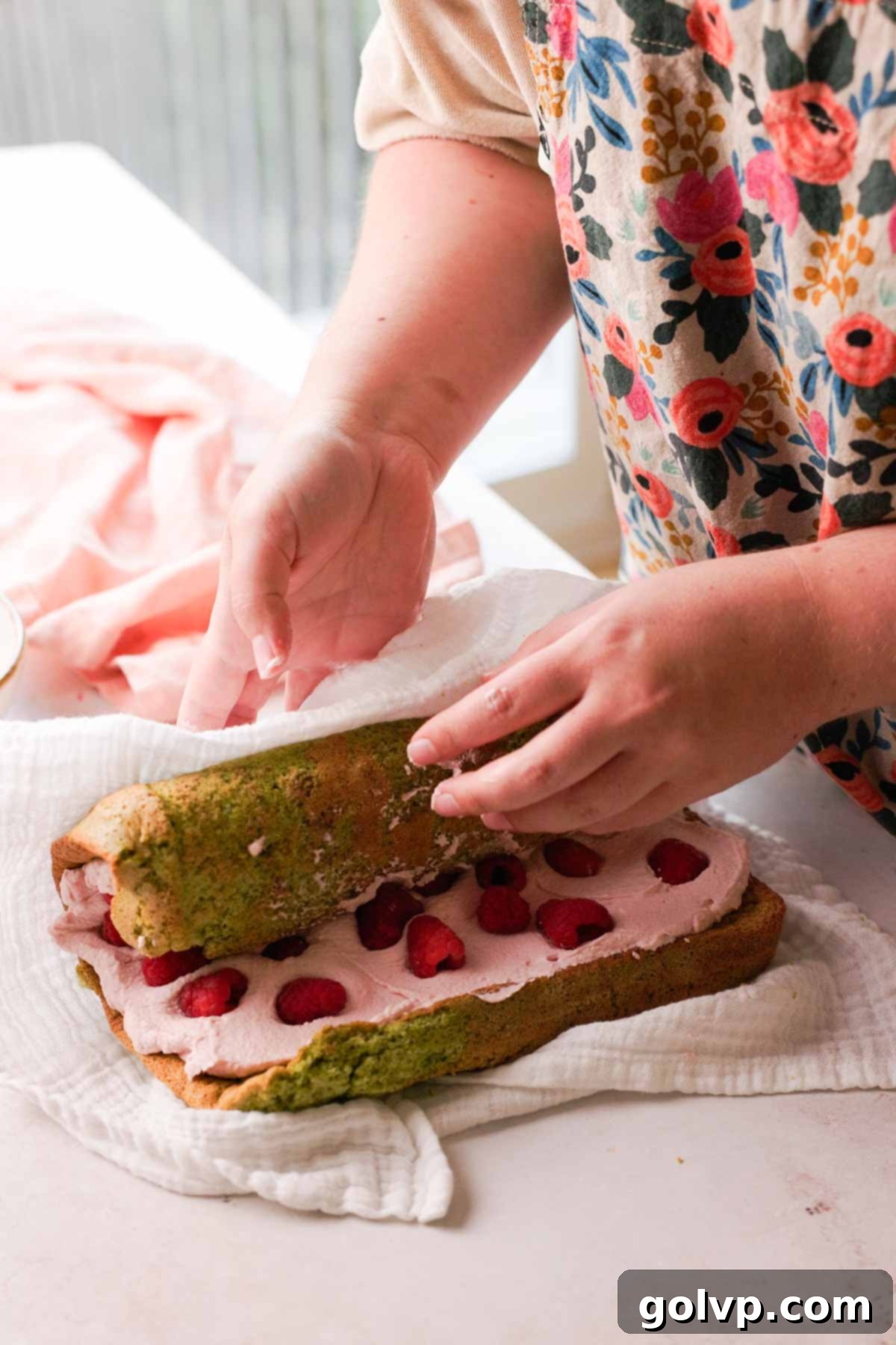 rolling filled pistachio sponge with raspberry filling