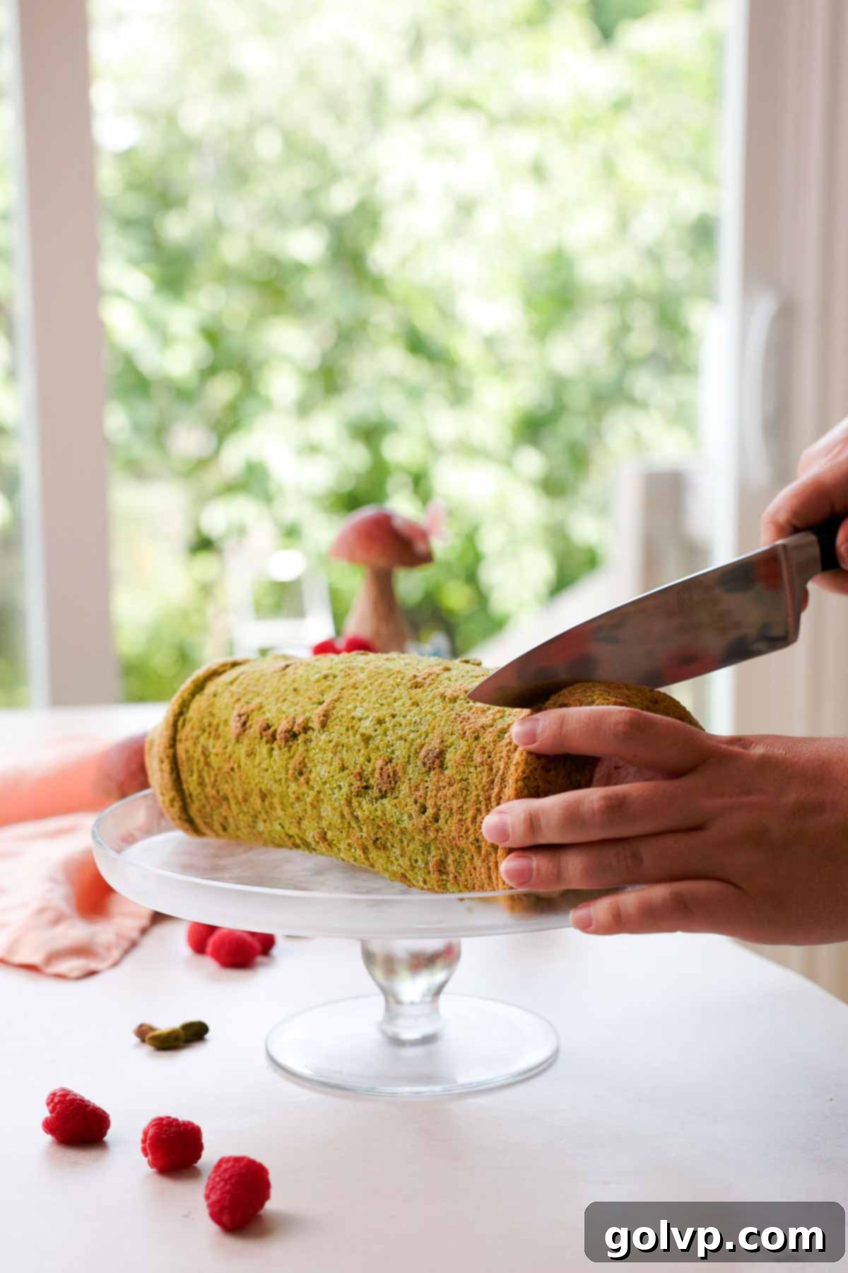 slicing ends off pistachio roll cake