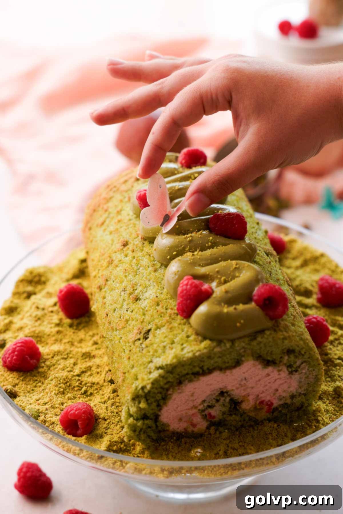 decorating pistachio cake roll with edible butterflies