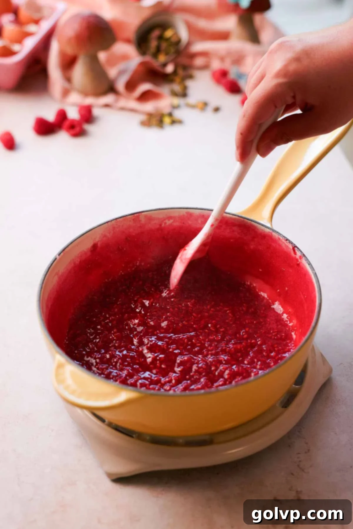 simmered and reduced raspberry sauce in saucepan