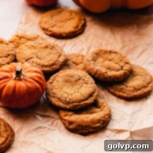 pumpkin spice snickerdoodle cookies on parchment paper