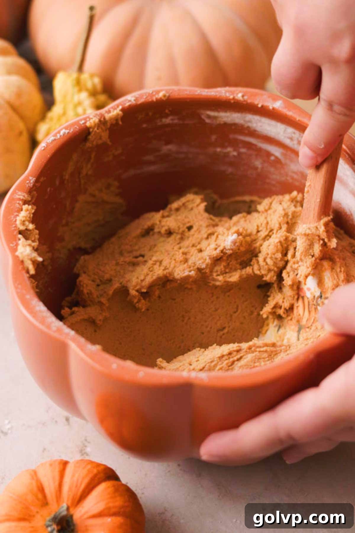 folding flour into the pumpkin spice snickerdoodle cookie dough